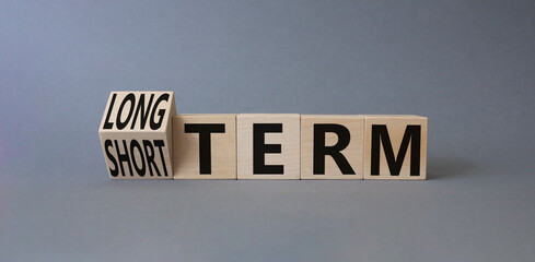 Long term vs Short Term symbol. Turned wooden cubes with words Long term and Short Term. Beautiful...