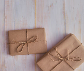 Christmas gift boxes and fir tree branch on wooden table, flat lay. Сhristmas background