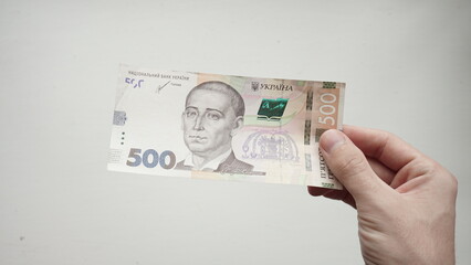 Ukrainian paper money with a face value of five hundred hryvnias in the hands of a man