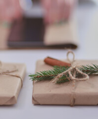 Hands of woman decorating christmas gift box. Hands of woman