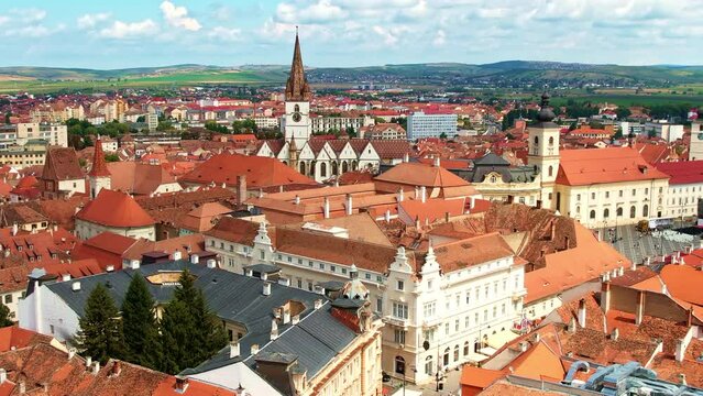 Aerial drone view of Cluj centre, Romania. Cityscape, roads with cars, old buildings, Saint Michael Church