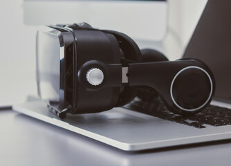 Virtual reality goggles on desk with laptop. business. 3d technology