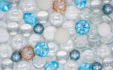 Beautiful background of transparent, light blue glass beads, crystals and white pearls. Copy space