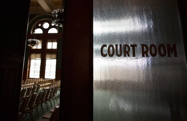 An old-fashioned court room door with words 