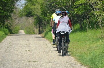 the family rides a bicycle in nature