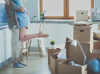 Portrait of young couple moving in new home. Young couple
