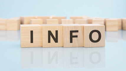 word INFO on wooden cubes over bright background with copy space