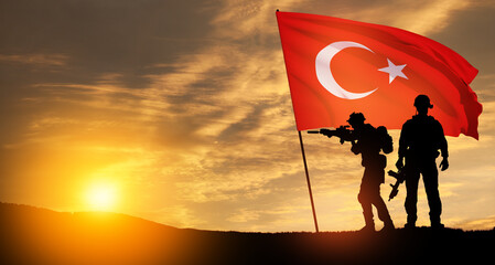 Silhouettes of soldiers with Turkey flag on background of sunset. Concept of crisis of war and...