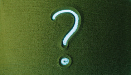 Hand drawing Question Mark Symbol in the Green Sand. Male hand writes a Symbol on the green sand with backlight. Top view 4k resolution