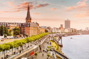 Sunset view of Dusseldorf city old town or Altstadt. Promenade on the banks of Rhine river. Travel and visit attractions in Germany. Popular city, center of Rheinland and Westphalia © EdNurg