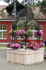 an old well decorated with flowers