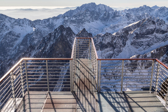 Viewing platform at Lomnicky Stit Peak, High Tatra Mountains with snow, on a clear, sunny, winter day, Slovakia