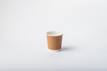 Empty paper cup for coffee made from biodegradable brown paper on a white background. Isolated for mock up