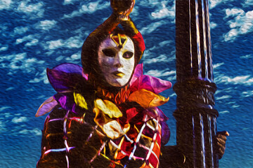 Carnival reveler wearing colorful costume with mask at the Carnival of Venice. The historic and amazing city full of canals and palaces in Italy.