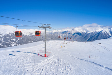 Fototapeta na wymiar Ski lift in the snowy mountains of Arkhyz resort city in Russia