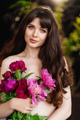 Naklejka premium an beautiful woman with long hair and bare shoulders and a bouquet of peonies