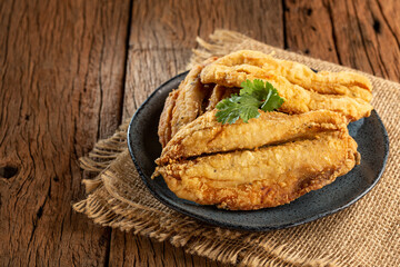 Fried sardines in the plate on the table.