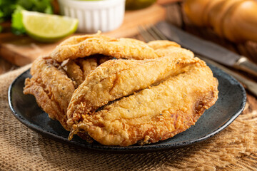 Fried sardines in the plate on the table.