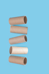 empty toilet paper rolls on blue background