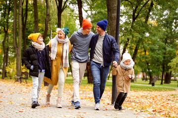 Happy Family of Five Have Fun in Autumn Golden Park. Leisure Time Spending Outdoor. Daily Lifestyle Concept.