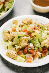 Close-up wedge chop salad with bacon