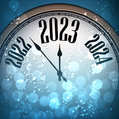 Fototapeta na wymiar Half hidden clock showing 2023 with blue bokeh lights.