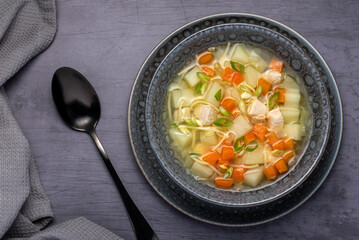 Food photography of soup, broth, noodle, potato, chicken, carrot