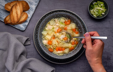 Food photography of soup, broth, noodle, potato, chicken, carrot