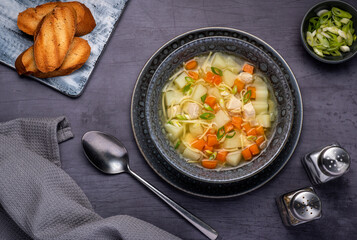 Food photography of soup, broth, noodle, potato, chicken, carrot