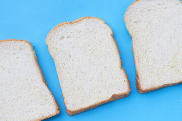 Sliced bread on blue background.