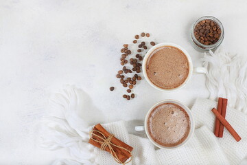Cozy home table with cappuccino coffee, cinnamon coffee beans, healthy breakfast with ingredients, hello autumn concept, hygge style, modern coffee shop advertisement, selective focus