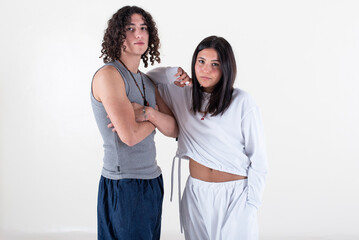 Naklejka premium Portrait of a young couple dressed in yoga clothes looking ti the camera white background.