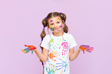 A little girl painted with multicolored paints will playfully have to create on a pink isolated background. Development of children's creativity for schoolchildren.