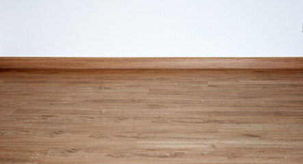 Laminate wood floor with blank white wall