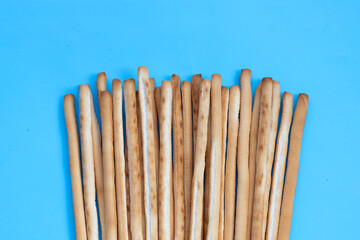 Bread sticks on blue background