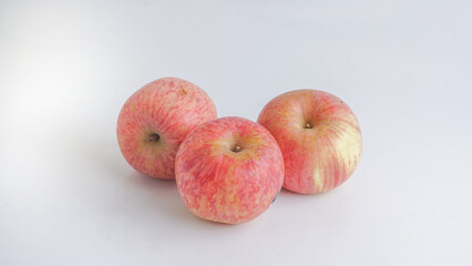 Three fresh Fuji apples on white background