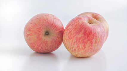 Three fresh Fuji apples on white background. Selective Focus
