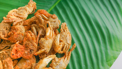 Delicious crispy baby crabs on a banana leaf. Selective focus concept