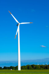Fototapeta premium renewable clean energy windmills.blades of wind generators.Environmentally friendly energy source.Wind energy price.Green renewable energy cost.