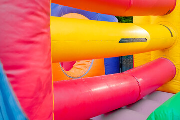 Detail of a brightly colored bouncy castle, empty without children.
