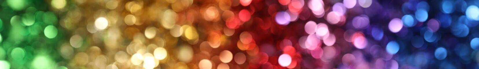 Abstract rainbow color background with a bokeh of lights in a colorful gradient.