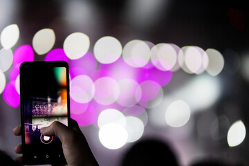 People taking photographs with smart phone during Live music concert