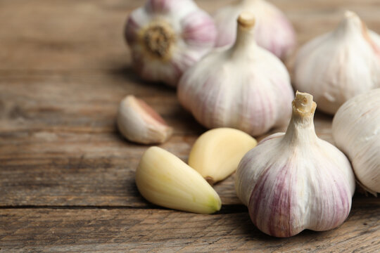 Fresh organic garlic on wooden table, closeup
