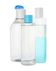 Bottles of micellar cleansing water on white background