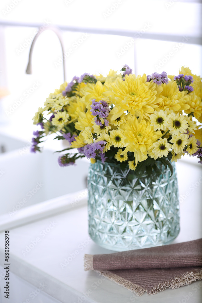 Wall mural vase with beautiful chrysanthemum flowers on countertop in kitchen. interior design