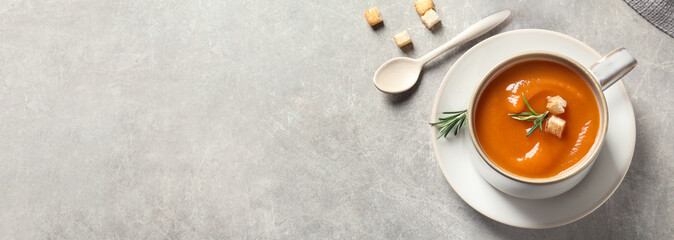 Tasty sweet potato soup on light grey table, flat lay with space for text. Banner design