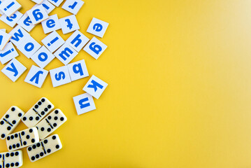 children's day, alphabet letters and dominoes on yellow background