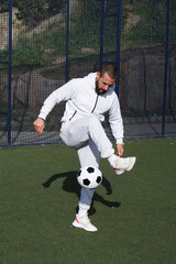 Young male soccer player juggles a ball on a soccer field © Imaxepress