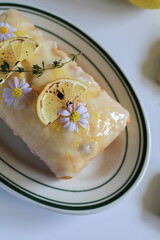 Homemade glazed lemon pound cake with slice fresh lemon decoration on top. Tasty dessert for winter holidays. Merry Christmas and Happy New Year atmosphere.