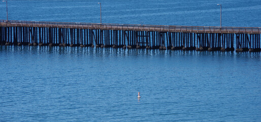 Public pier in Avila Beach at the blue pacific ocean in California